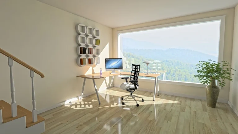 A cozy home office setup with a computer on a desk and a comfortable chair, ideal for remote work.